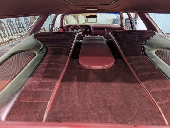 Custom wagon rear interior in burgundy detailed by Grindtime Mobile Detailing